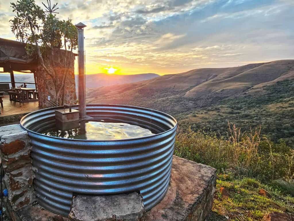Scenic sunset over Wolwekrans with water tank and mountain landscape.